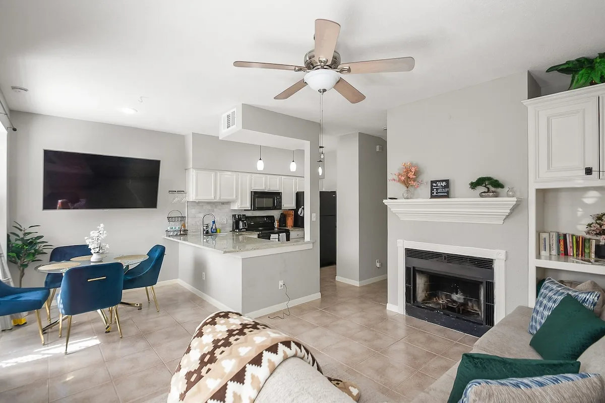 King bedroom in the Houston condo with soft bedding and a television