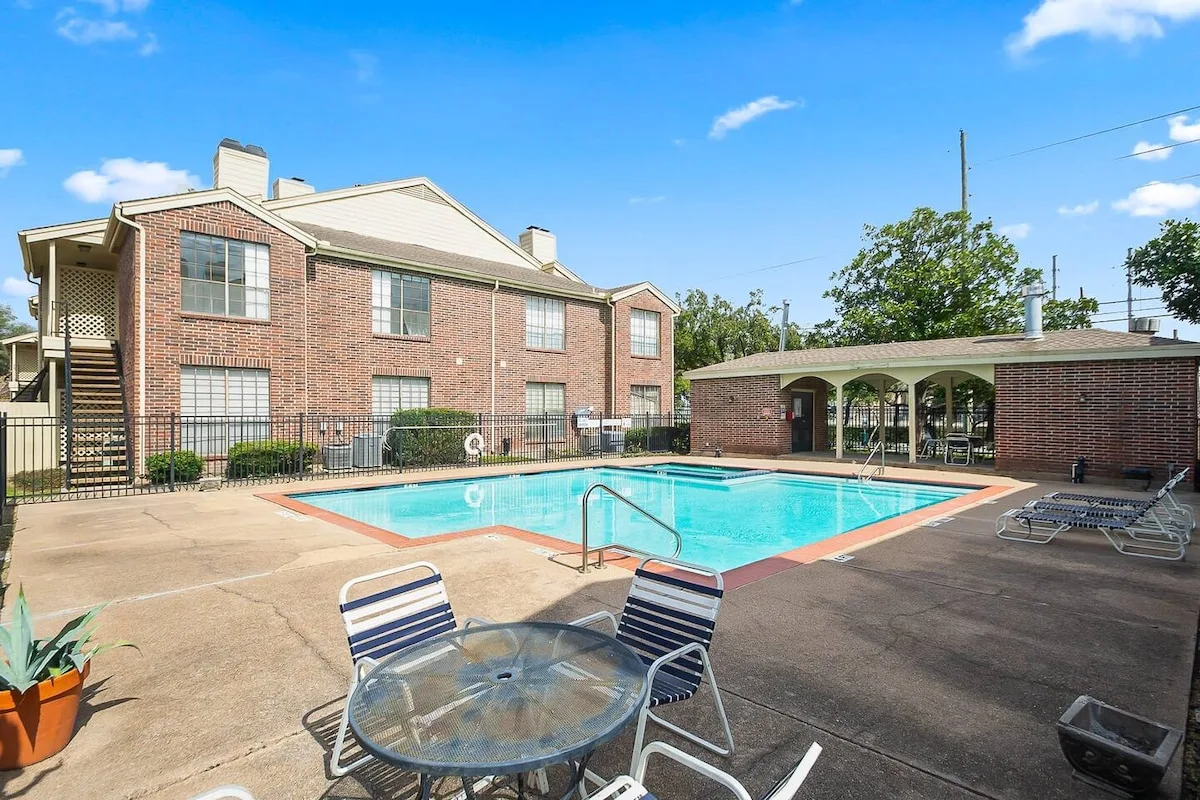 Fully equipped condo kitchen with cabinets, appliances, and a breakfast counter